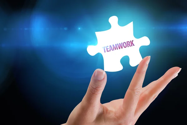 Word teamwork and hand showing jigsaw — Stock Photo, Image