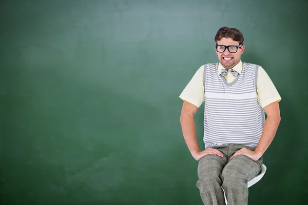 Geeky hipster sitting on stool — Stock Photo, Image