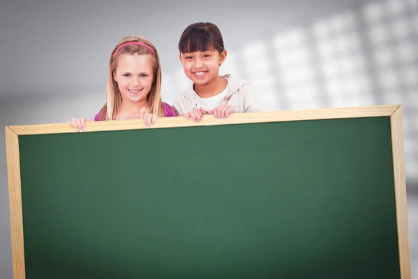 Girls behind a blank panel — Stock Photo, Image