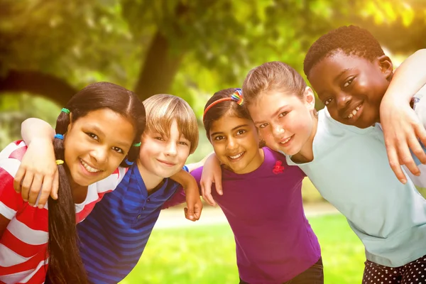 Children forming huddle at park — Stock Photo, Image