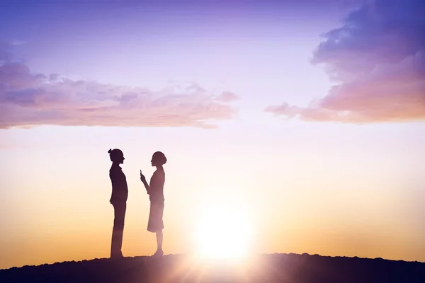 Businesswomen talking against sunset — Stock Photo, Image