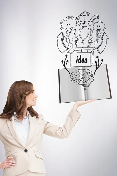 Pretty businesswoman showing a book — Stock Photo, Image