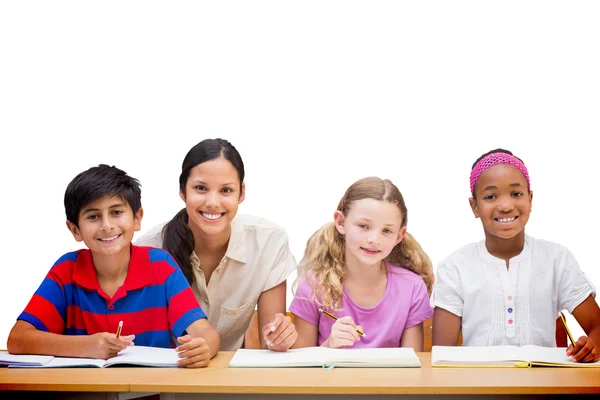 Teacher helping pupils in library — Stock Photo, Image