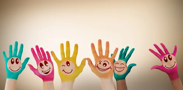 Hands with colourful smiley faces — Stock Photo, Image