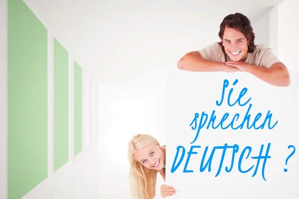 Smiling couple with whiteboard — Stock Photo, Image