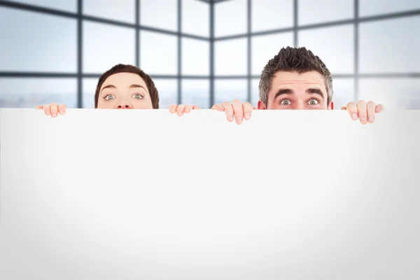 Man and woman hiding behind  board — Stock Photo, Image