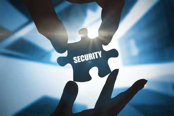 Word security and hands holding jigsaw — Stock Photo, Image