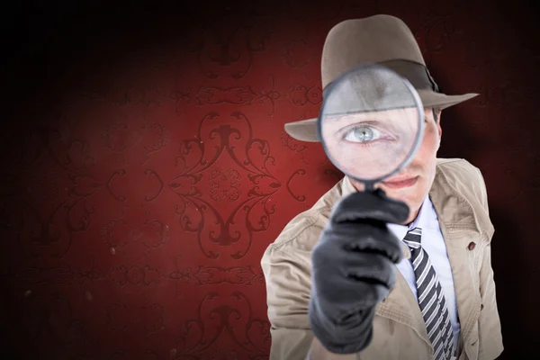 Spy looking through magnifier — Stock Photo, Image