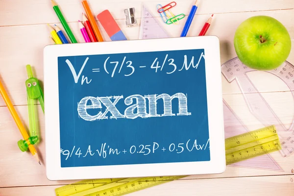 Exam against students desk with tablet pc — Stock Photo, Image