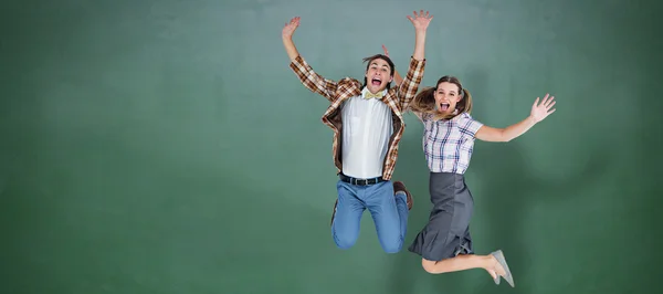 Geeky hipsters jumping and smiling — Stock Photo, Image