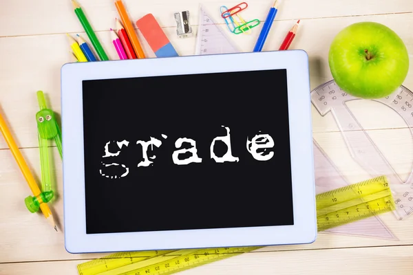 Word grade against students tablet — Stock Photo, Image