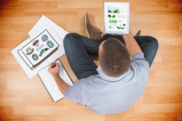 Creative businessman looking at tablet — Stock Photo, Image