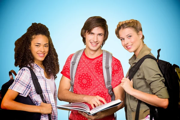 College students reading book in library — Stock Photo, Image