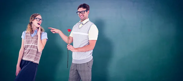 Hipster holding rose and pointing girlfriend — Stock Photo, Image