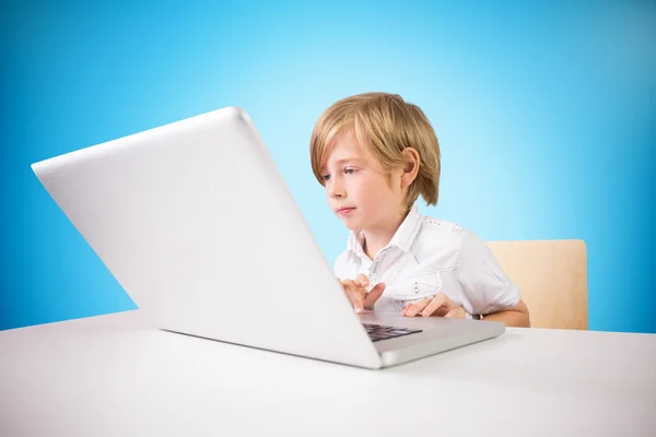 Cute boy using laptop — Stock Photo, Image