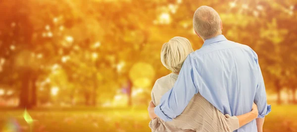 Mature couple hugging and looking — Stock Photo, Image