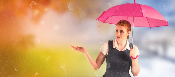 Pretty redhead businesswoman holding umbrella — Stock Photo, Image