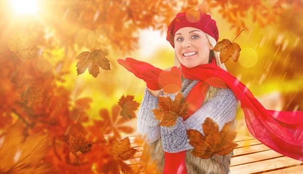 Blonde in winter clothes with hands out — Stock Photo, Image