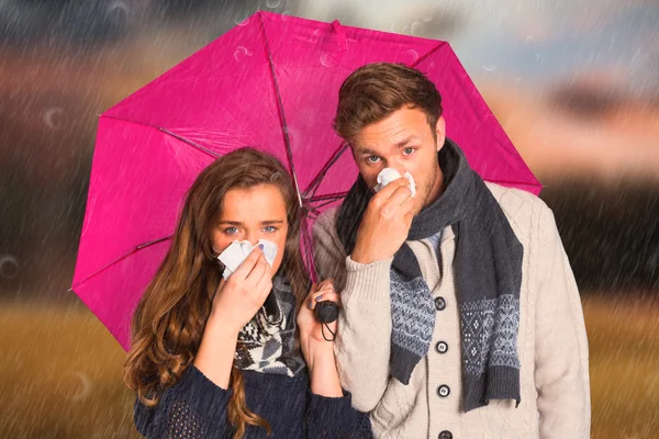 Couple blowing nose while holding umbrella — Stock Photo, Image