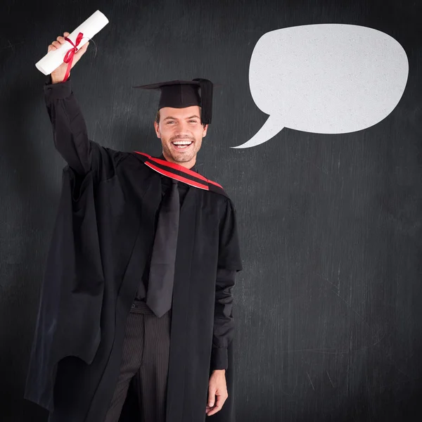 Usmívající se hezký boy ukazuje svůj diplom — Stock fotografie