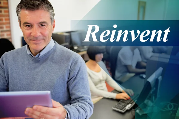 Teacher holding a tablet pc in computer room — Stock Photo, Image