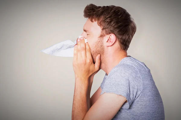 Close up side view of man blowing nose — Stock Photo, Image