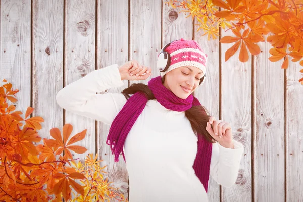 Winter brunette listening to music Royalty Free Stock Images