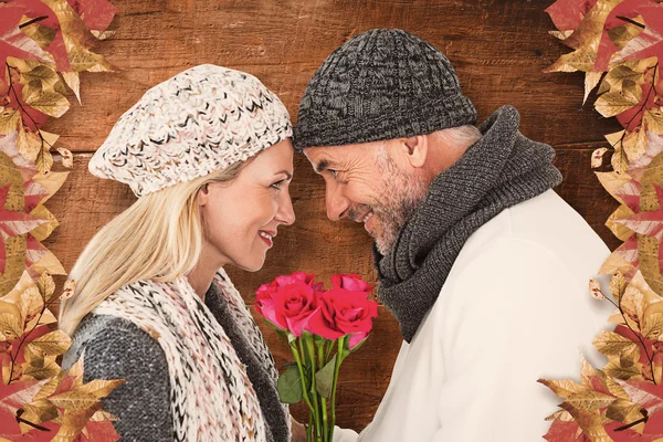 Cute couple holding rose while looking at each — Stock Photo, Image