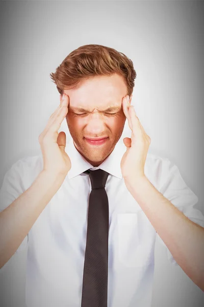 Young businessman getting a headache — Stock Photo, Image