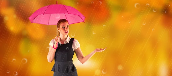 Pretty redhead businesswoman holding umbrella — Stock Photo, Image