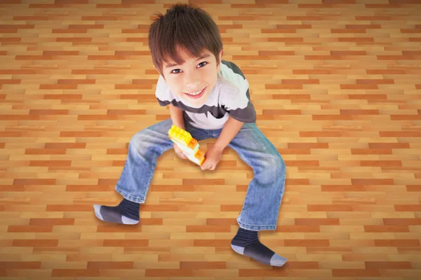 Cute boy sitting with building blocks — Stock Photo, Image