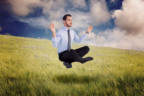 Relaxed businessman sitting in lotus pose — Stock Photo, Image