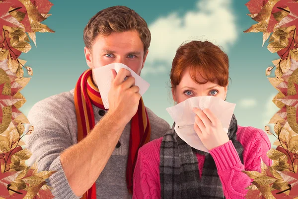 Couple blowing noses into tissues — Stock Photo, Image