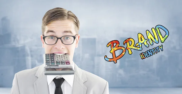 Geeky smiling businessman biting calculator — Stock Photo, Image