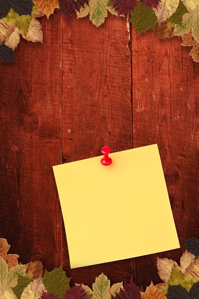 Illustrative image of pushpin on yellow paper — Stock Photo, Image