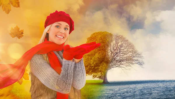 Blonde in winter clothes with hands out — Stock Photo, Image