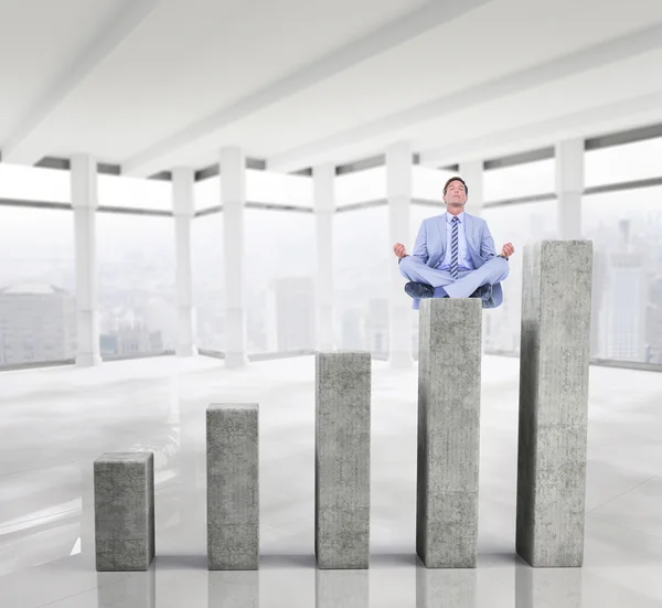 Calm businessman meditating in lotus pose — Stock Photo, Image