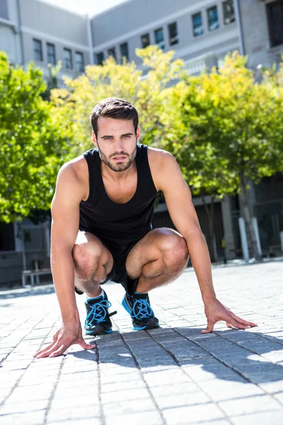 Atleta in posizione accovacciata — Foto Stock