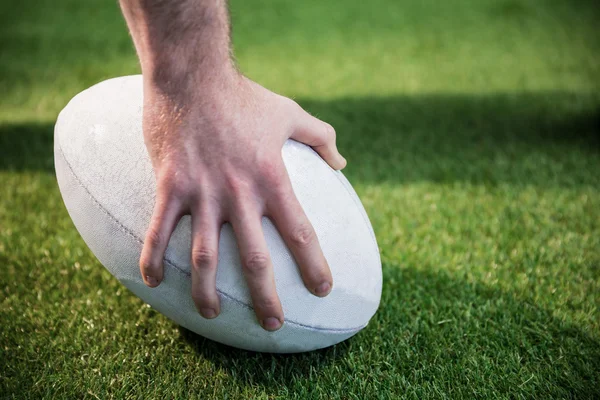 Jugador posando una pelota de rugby — Foto de Stock