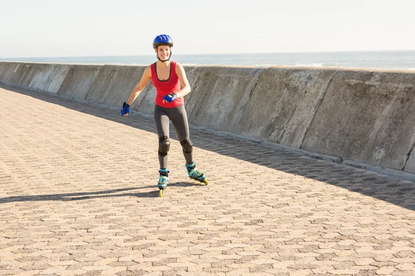 Smiling sporty blonde skating — Stock Photo, Image