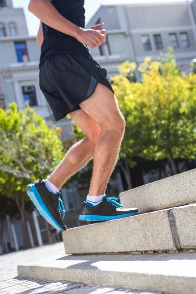 Athlete jogging up the stairs — Stock Photo, Image