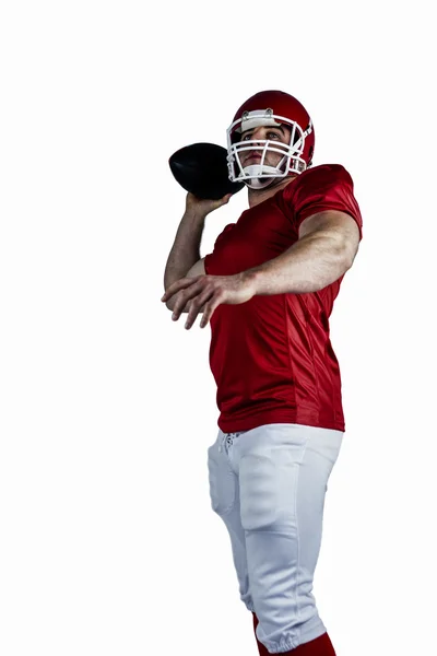 Futbol amerykański gracz rzuca piłkę — Zdjęcie stockowe
