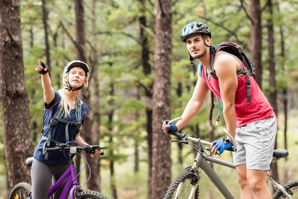 Casal em bicicletas olhando para longe — Fotografia de Stock