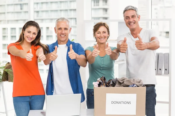 People donating and doing thumbs up — Stock Photo, Image