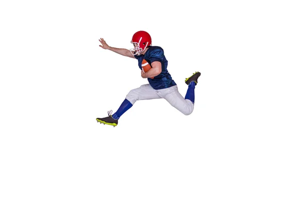 Jogador de futebol pulando com a bola — Fotografia de Stock
