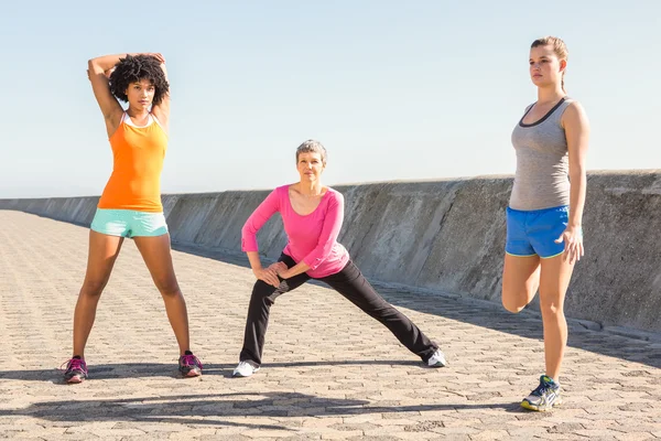 Sporty women stretching together — Stock Photo, Image