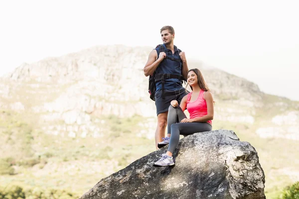 Happy joggers standing on rock — Stock Photo, Image