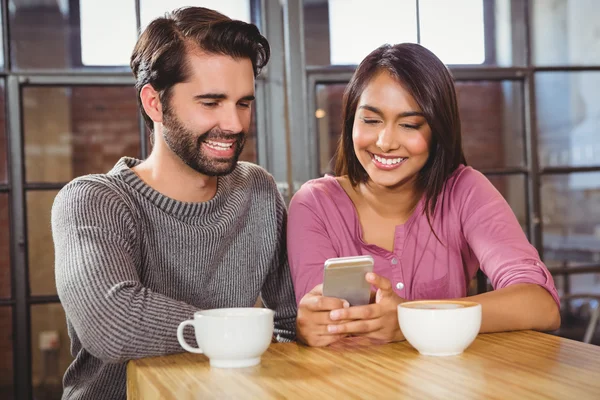 Linda pareja mirando un teléfono inteligente — Foto de Stock