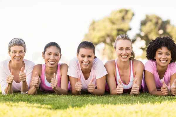 Smiling women lying in a row — Stock Photo, Image