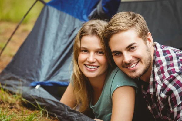 Casal feliz deitado em uma tenda — Fotografia de Stock